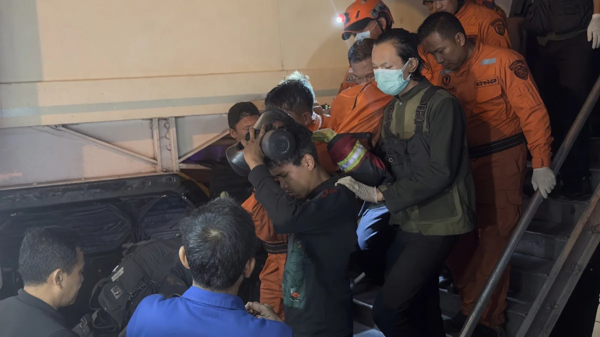 Petugas Damkar Manado membantu proses penyelamatan korban kebakaran